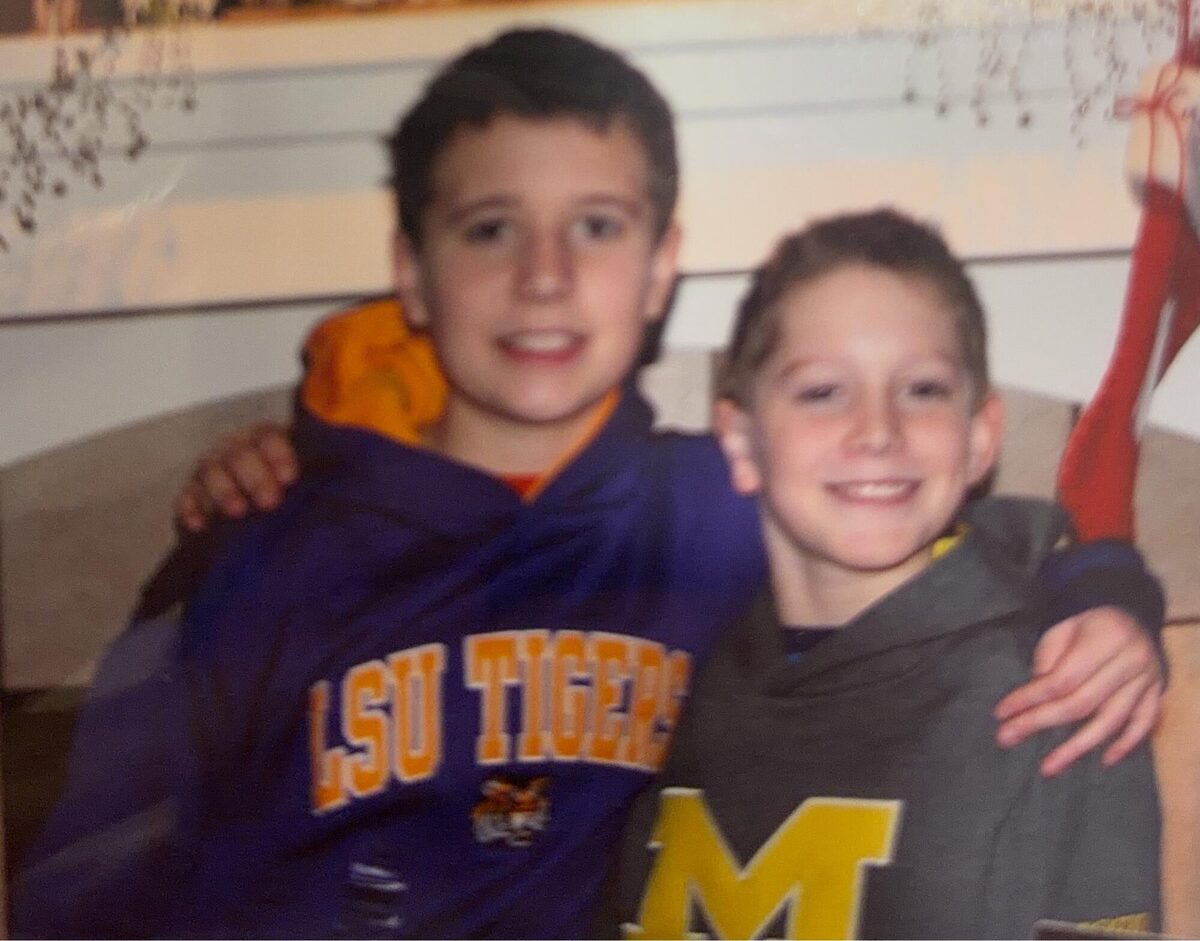 Justin and his brother in LSU and Michigan gear
