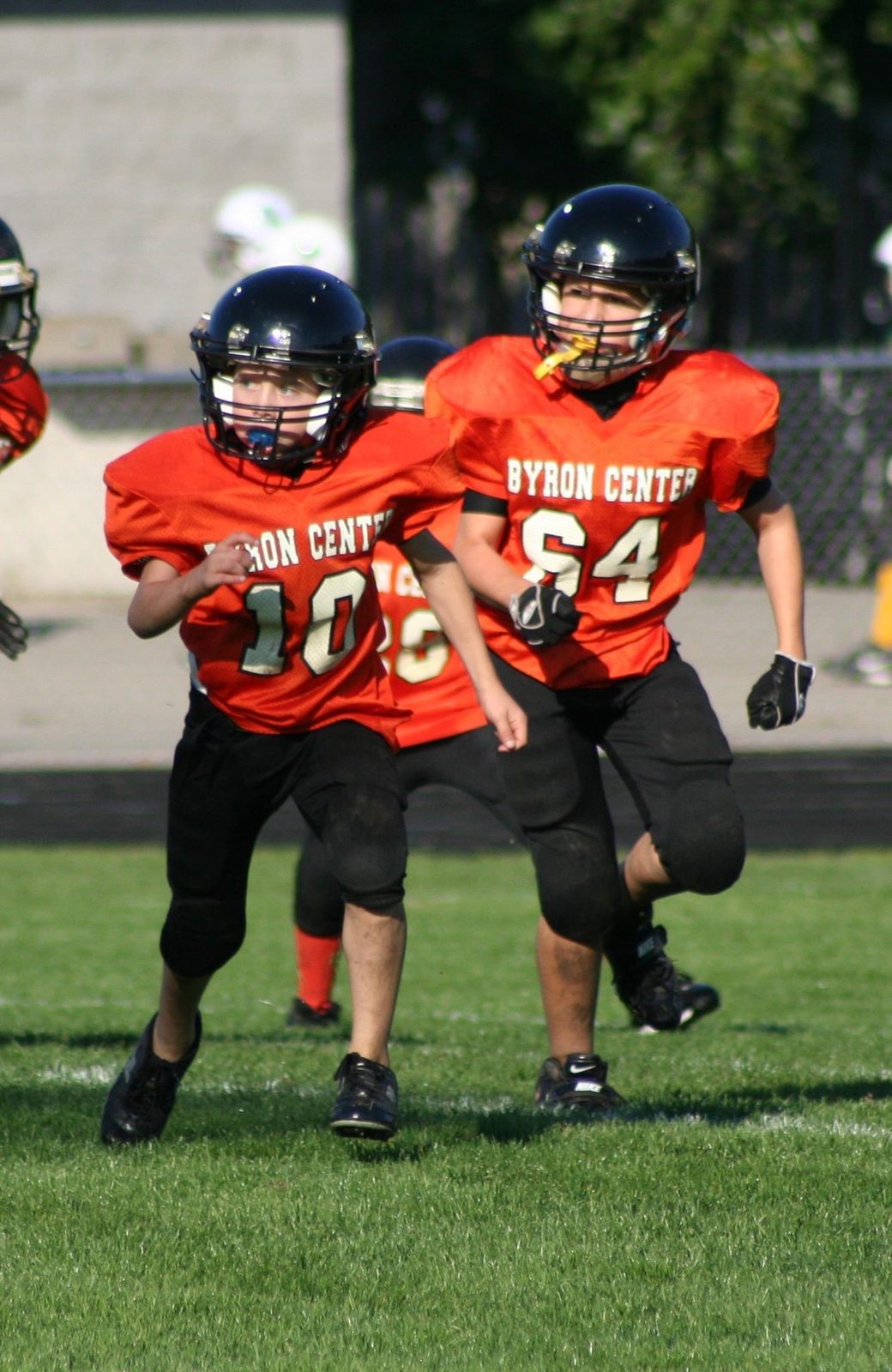 Justin in a Byron Center youth tackle-football uniform on the field