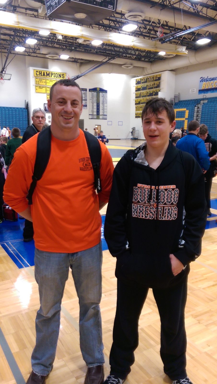 Justin in a Byron Center wrestling hoodie at a wrestling meet