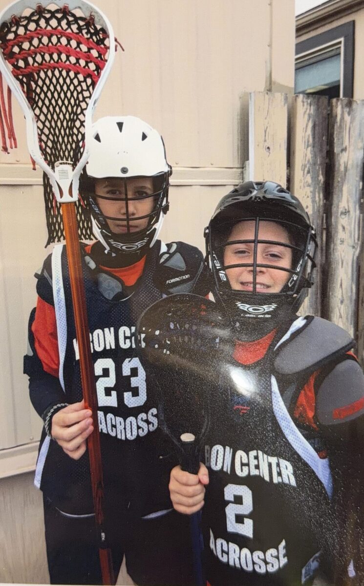 Justin and a teammate in Byron Center lacrosse gear, numbers 2 and 23